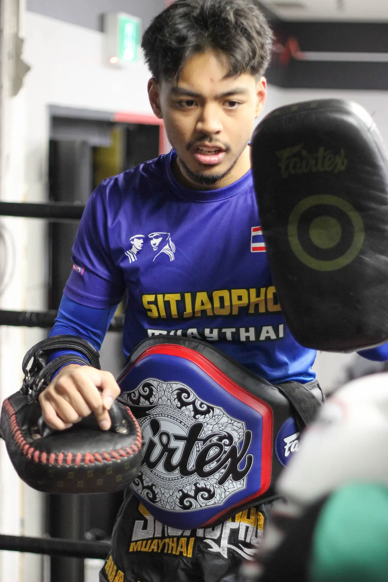 Justin coaching a student on the pads